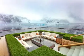 A deck with a couch and a fire pit overlooking a body of water

AI-generated content may be incorrect.