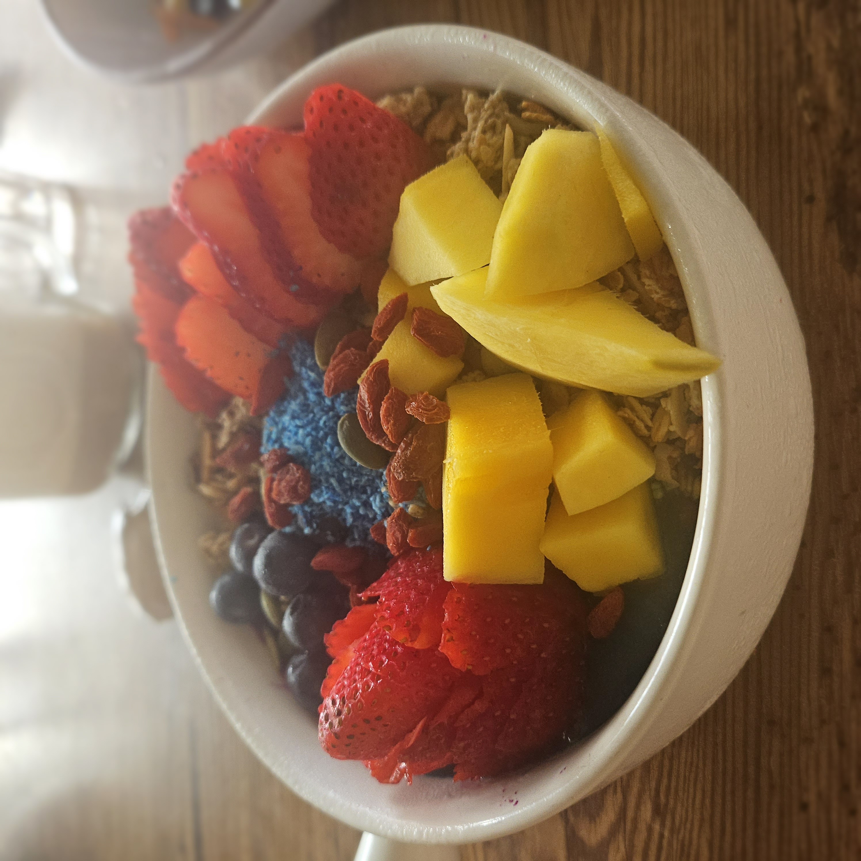 Smoothie bowl from Eduardo's with berries, mango granola and the prettiest pink and purple smoothie