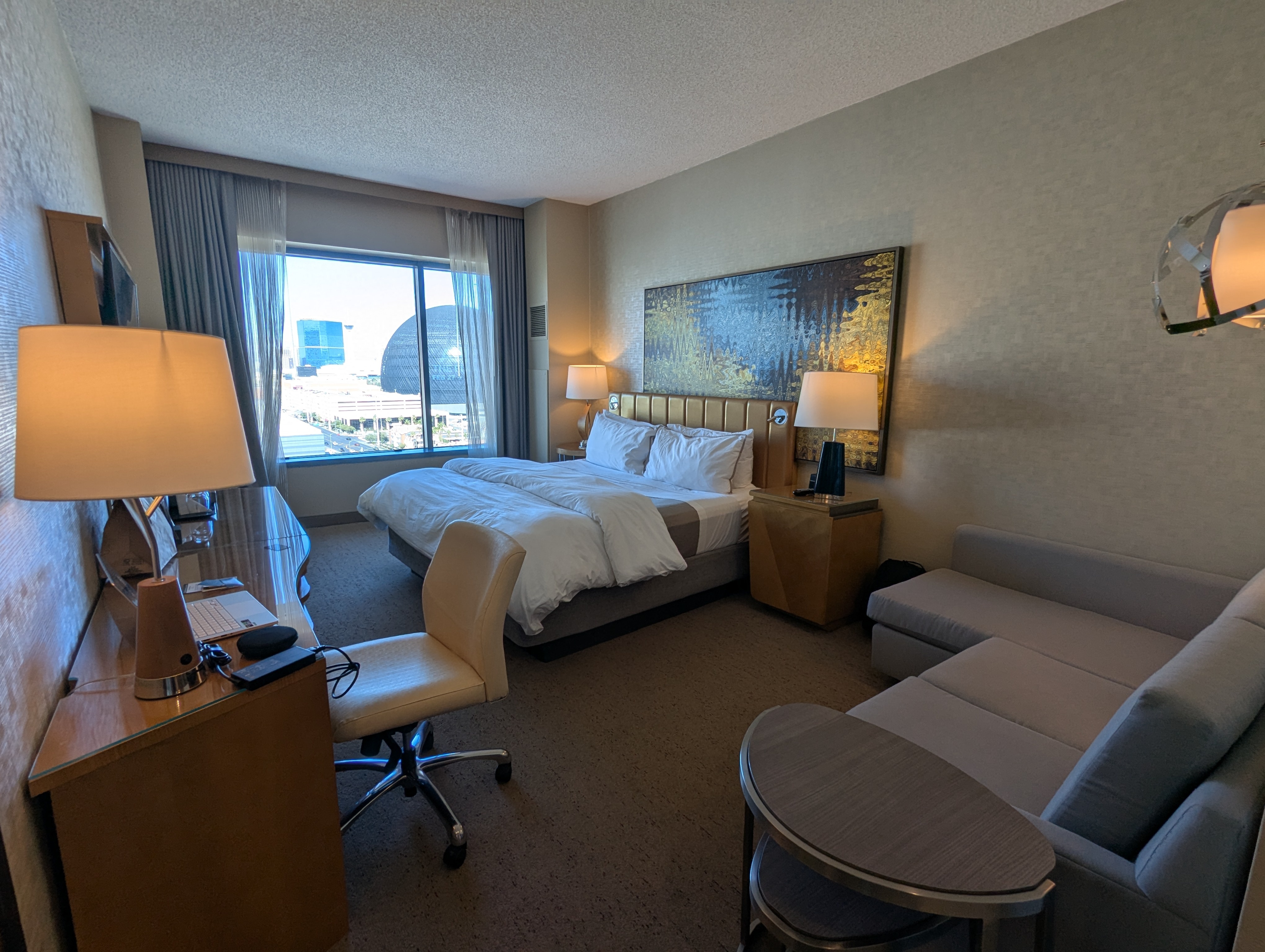 Premium hotel room with large sofa and a view of The Sphere