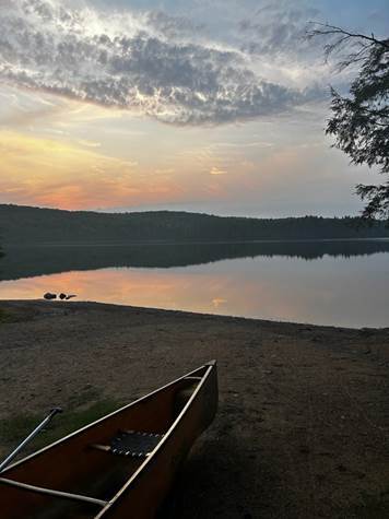 A boat on the shore of a lake