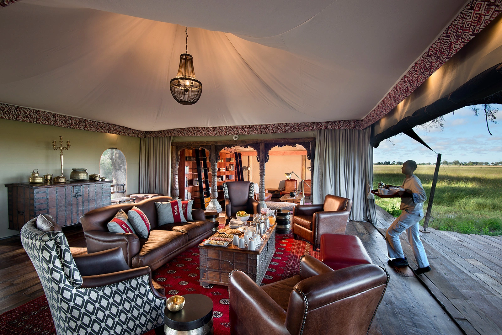 02Great-Plains-Duba-Plains-Camp-main-lounge-with-waiter.jpg