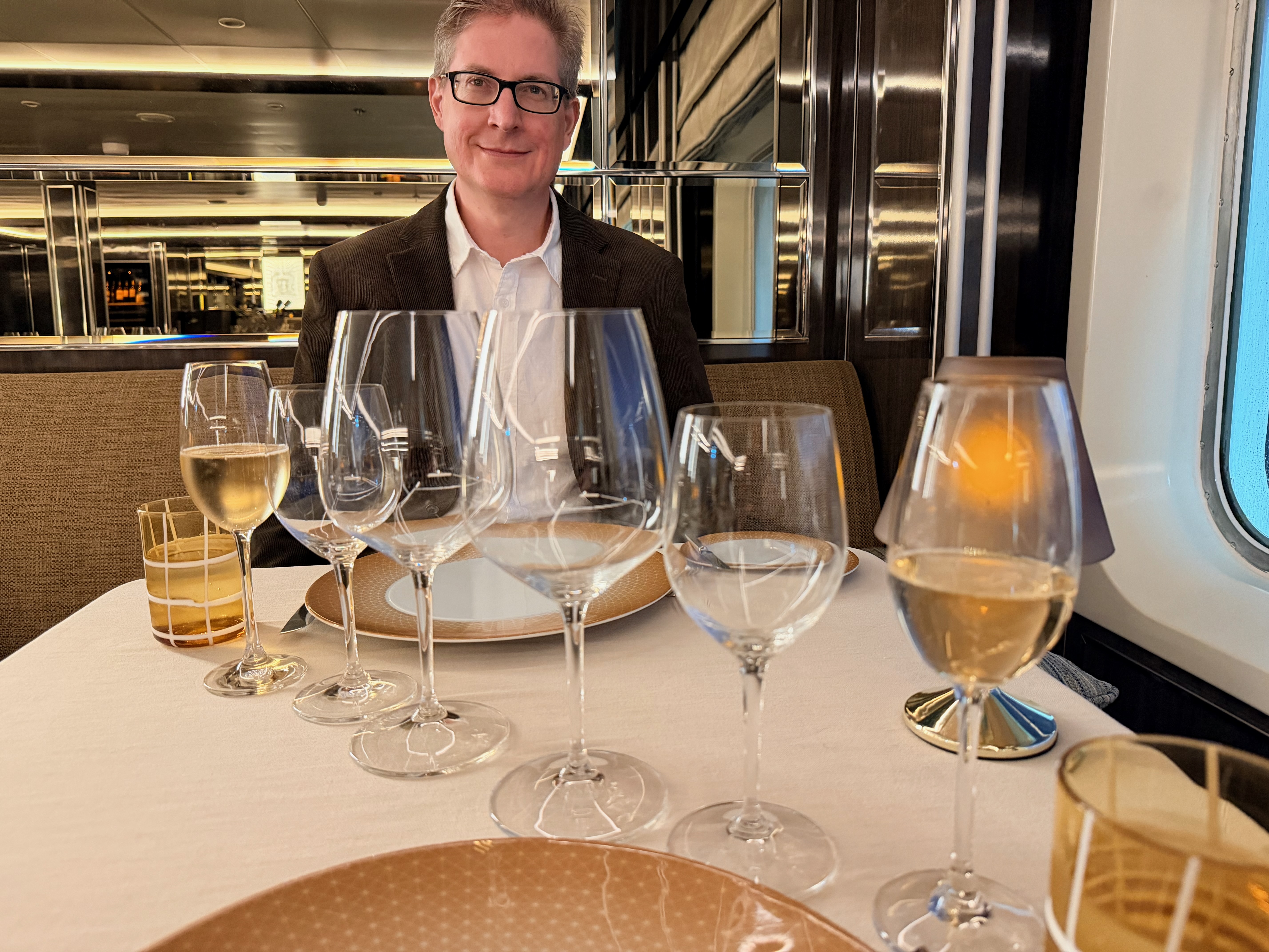 man sitting at set table of La Dame restaurant on the Silversea Silver Shadow