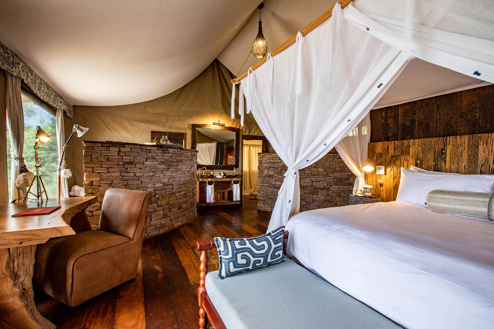 07Great-Plains-Zanji-Suite-at-Tembo-Plains-bedroom-with-bathroom.jpg