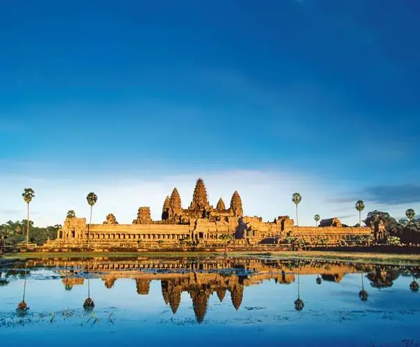 A large building with a body of water with Angkor Wat in the background

AI-generated content may be incorrect.