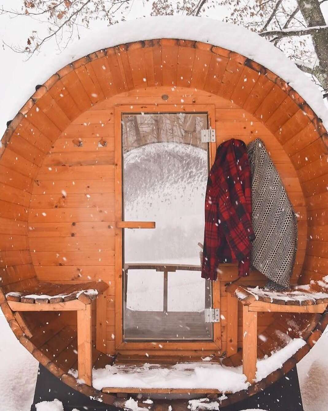 If you were aiming for cozy and you find yourself in a barrel-shaped sauna nestled in the snow, it’s safe to say you’ve overachie